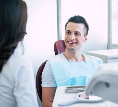 Dentist smiling at dentist about COVID 19 safety protocols