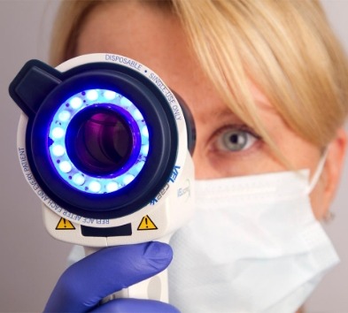 Dentist performing oral cancer screening