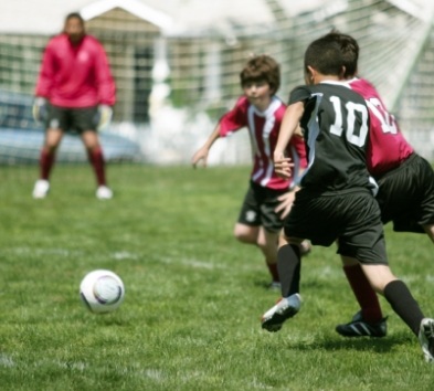 Teens wearing athletic mouthguard as they play soccer