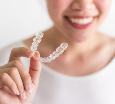 Patient holding clear aligner treatment