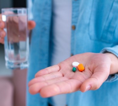 Hand holding antibiotic therapy pills