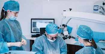 an oral surgeon performing dental implant placement surgery