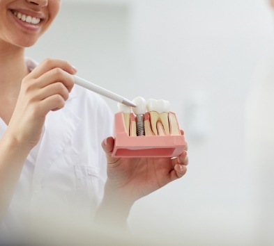 an oral surgeon performing dental implant placement surgery