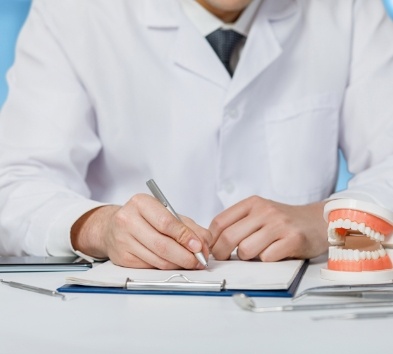 Dental team member helping patient complete dental insurance forms