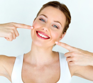 Woman pointing to her teeth