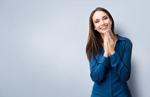 Woman in dark blue shirt standing and smiling
