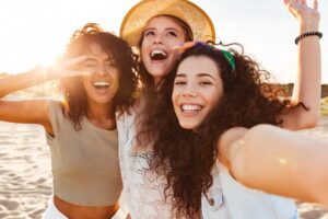 Group of friends with perfect smiles enjoying their summer
